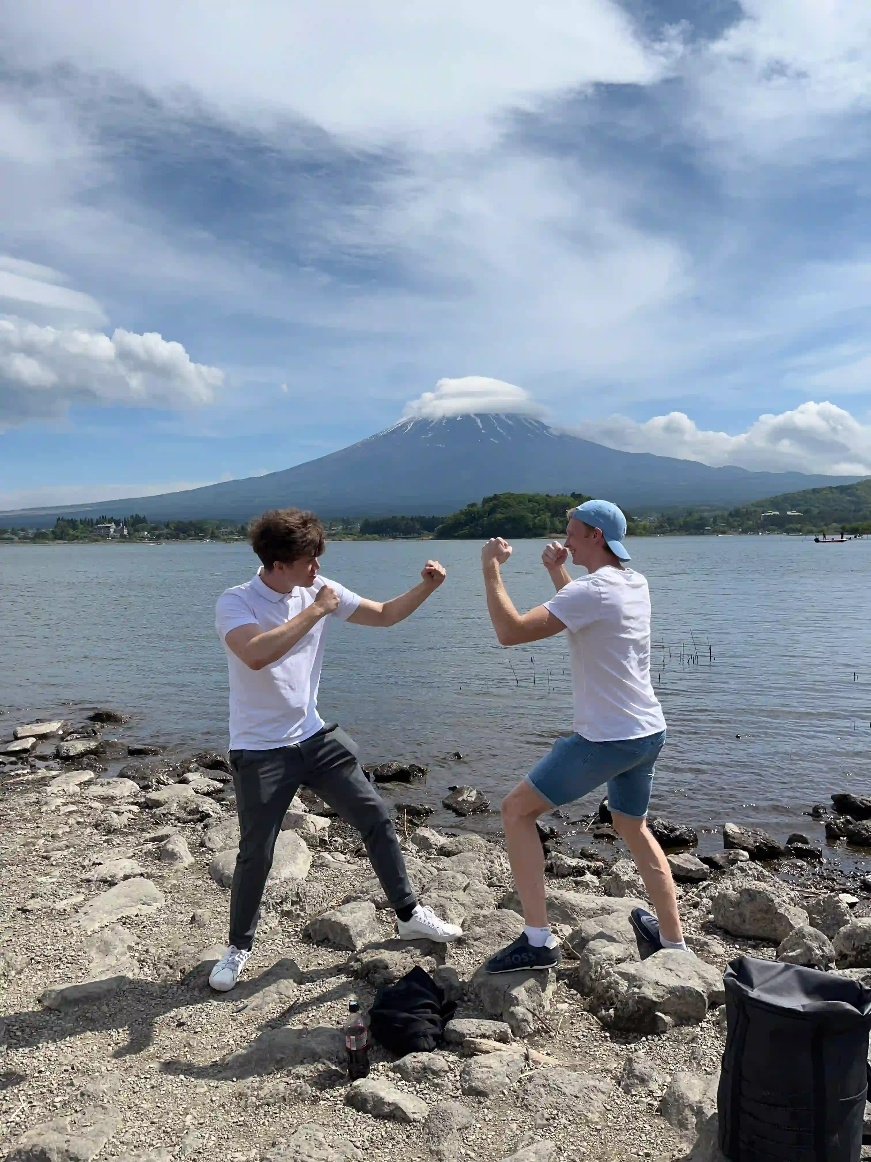 Two people play fighting with Mount Fuji in the background